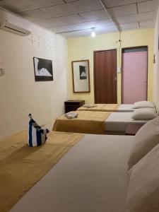 珍南海滩THE COTTAGE LANGKAWI的一间设有两张床和紫色门的房间