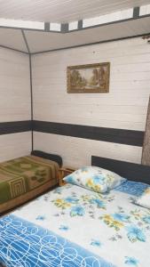 亚列姆切Відпочинок у Євгена та Оксани的一间卧室设有两张床,墙上挂着一幅画