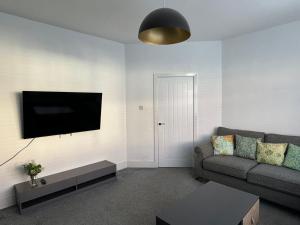 Great CoatesUrban Retreat的带沙发和平面电视的客厅