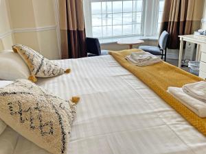 布莱克浦总统酒店 的一张白色大床,上面有枕头