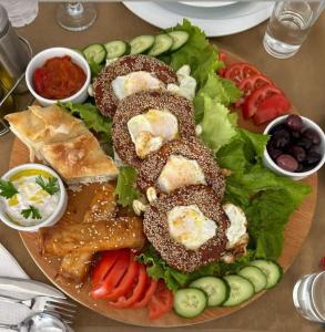 斯特鲁加Hotel Montenegro的桌上一盘带面包和蔬菜的食物