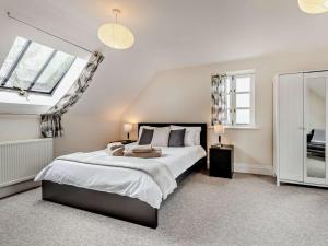 斯特明斯特牛顿3 bed property in Sturminster Newton Dorset RCORN的一间卧室设有一张大床和两个窗户。