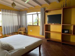 埃斯孔迪多港拉哈西恩德套房酒店的一间卧室配有一张床和一台平面电视