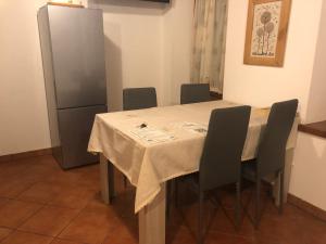 莱维科特尔梅Casa Weber Levico Terme的餐桌、椅子和冰箱