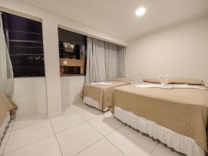 马拉戈日Pousada do Alemão的一间卧室设有两张床和窗户。