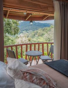 CopeyCedrela Eco-Lodge & Restaurante的一间卧室设有一张桌子和椅子的阳台