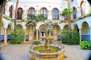 罗达德瓦拉Apartamento Primera Linea Playa的庭院中间有喷泉的建筑