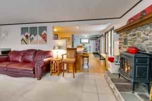Montgomery CenterPet-Friendly Home with Deck 4 Mi to Jay Peak Resort的客厅设有真皮沙发和壁炉