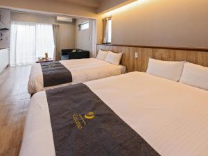 北谷町Family Condo Chatan Hills by Coldio Premium的一间酒店客房,房间内设有两张床