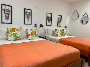 卡塔赫纳Makena La Boquilla Beach Hostel的两张睡床彼此相邻,位于一个房间里