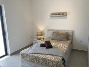 马尔萨斯卡拉Elegant Maisonette in Malta by AssetFlow PRO的一间卧室配有一张大床、一盏灯和一张四柱床