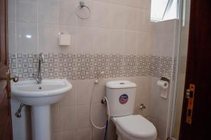 蒙巴萨H20 APARTMENTS NYALI的一间带卫生间和水槽的小浴室