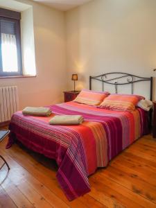 帕哈雷斯波萨达真实帕哈雷斯酒店的一间卧室配有一张大床,提供色彩缤纷的毯子和枕头