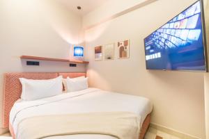 马拉喀什JEMAA EL FNA Suites & Spa的一间卧室配有一张床和一台平面电视