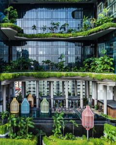 新加坡PARKROYAL COLLECTION Pickering, Singapore的一座带绿色屋顶的办公楼,里面种植了植物