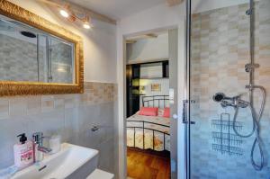 法扎纳Apartment Etta的一间带水槽和淋浴的浴室以及一张床