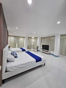 锡朗EliJosh Resort and Events Place的一间大卧室,配有一张大床和一台平面电视
