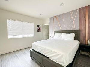 洛杉矶Cozy 3BR Oasis for Your Next Adventure in LA - WO的一间卧室设有一张大床和一个窗户。