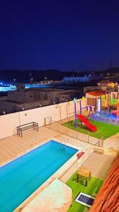 Ash Shishahشاليهات ميرامار مكة الحسينية的一个带滑梯的游泳池和一个游乐场