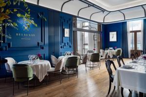 格乔Palacio Arriluce Hotel的一间配备有桌椅的用餐室和蓝色的墙壁