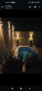 塞拉内格拉Casa das posses para 8 pessoas的一座拥有两株盆栽植物和灯的游泳池
