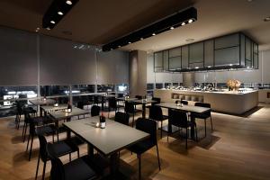 蔚山蔚山新罗舒泰酒店的一间带桌椅的餐厅和一间厨房