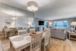 阿米莉亚岛Oceanfront Elegance at AIP Resort的用餐室以及带桌椅的起居室。