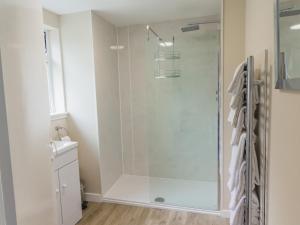 CrayKeepers Cottage - Uk30246的浴室里设有玻璃门淋浴