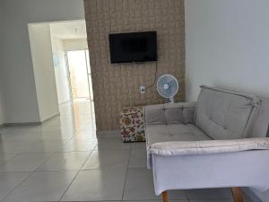 盖比姆Casa Cantinho da Família - Praia de Guaibim -的带沙发和平面电视的客厅