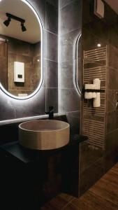亚琛Atrium Apartments Aachen的一间带圆形水槽和镜子的浴室