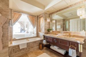 大连大连一方城堡豪华精选酒店的一间带浴缸和大镜子的浴室