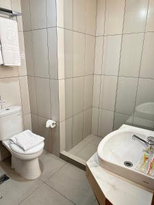 泗水d'primahotel Jemursari Surabaya的浴室配有卫生间、盥洗盆和淋浴。