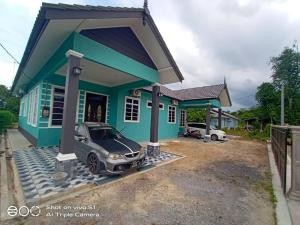 Gemia Rumah Tamu - 3 bilik aircond - near nasi dagang Atas tol的停在蓝色小房子外的汽车