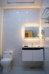巴哈瓦尔布尔The Edition Bahawalpur的白色的浴室设有卫生间和镜子