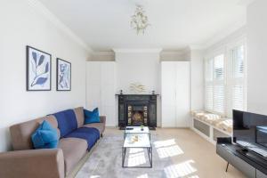 伦敦Tranquil 2BR Fulham Gem with Terrace Near Shops的带沙发和壁炉的客厅