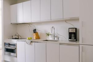 纽约Sonder Battery Park的白色的厨房配有水槽和微波炉