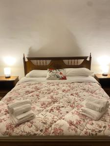 斯佩洛CASA VACANZE Da Mario Lu Ciclista的一间卧室配有一张床,上面有两条毛巾
