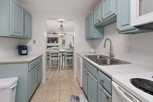 圣西蒙斯岛Selah的厨房配有蓝色橱柜和水槽