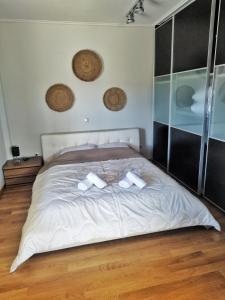 卡利斯托斯Aris Apt的一间卧室配有一张带两条白色毛巾的床