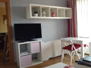 马德里卡勒马里西奥勒让德公寓的客厅配有电视和带椅子的桌子