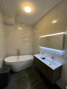 多德雷赫特Artistic apartment, City Centre Dordrecht的白色的浴室设有浴缸和水槽。