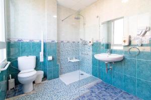 萨贡托Hotel Sagunto的浴室配有卫生间、盥洗盆和淋浴。