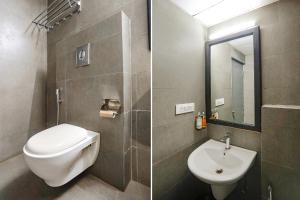 Vibhuti KhandFabHotel Ramayana的一间带卫生间、水槽和镜子的浴室