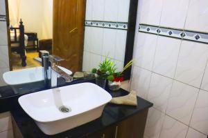 马查科斯Saba Holiday Homes的浴室设有白色水槽和镜子