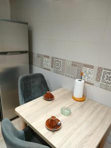 阿尔及尔les temps heureux的厨房配有一张桌子、两把椅子和一张桌子