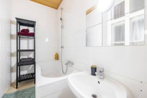 维也纳Charming spacious apartment的白色的浴室设有水槽和浴缸。