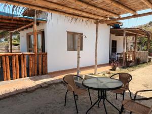 卡诺阿斯德蓬萨尔Bungalows Sol y Mar的房屋前设有带桌椅的天井。