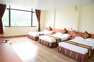 Làng LapThiên Hương Hotel的带大窗户的客房内的四张床