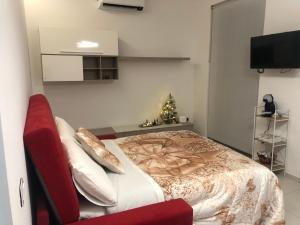 福利尼奥Casa Vacanze Il Divano Rosso的一间卧室,配有圣诞树和一张床