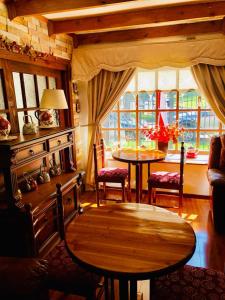 特木科Hostal Collins House的客厅配有桌椅和窗户。